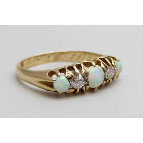 7069 - An 18ct gold, opal and diamond ring, 3.4g, N/O, boxed, one opal chipped