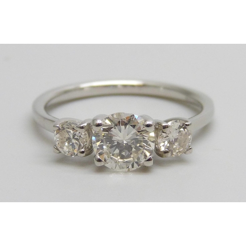 7084 - A hallmarked platinum and three stone diamond ring, total diamond weight 1.16cts, centre stone 0.79c... 