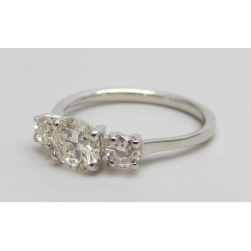 7084 - A hallmarked platinum and three stone diamond ring, total diamond weight 1.16cts, centre stone 0.79c... 