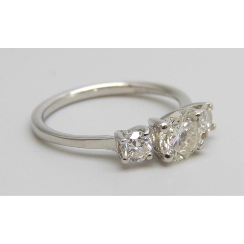 7084 - A hallmarked platinum and three stone diamond ring, total diamond weight 1.16cts, centre stone 0.79c... 