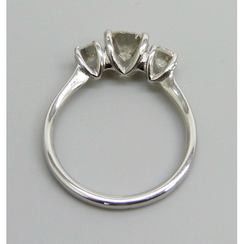 7084 - A hallmarked platinum and three stone diamond ring, total diamond weight 1.16cts, centre stone 0.79c... 