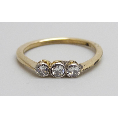 7085 - A yellow metal set three stone diamond ring, 1.7g, M