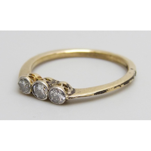 7085 - A yellow metal set three stone diamond ring, 1.7g, M