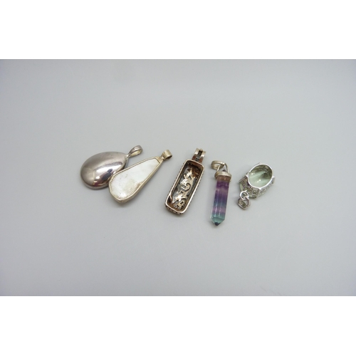 7098 - A collection of silver mounted pendants, 34g