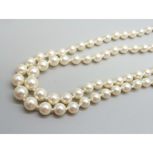 7101 - A two strand pearl necklace with a silver gilt clasp, 30g, 42cm