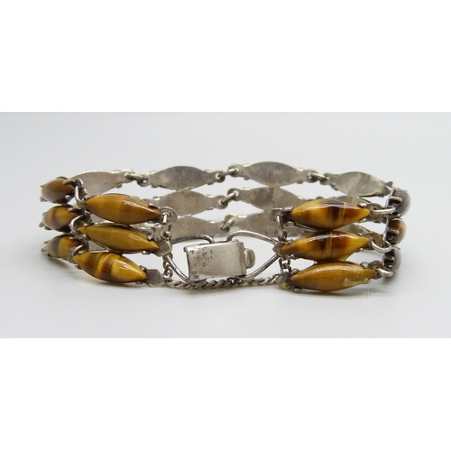 7103 - A white metal tiger's eye bracelet, one stone missing, 15g