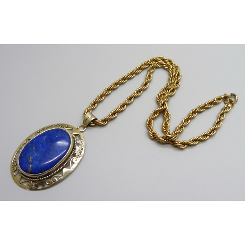 7123 - A large silver gilt lapis lazuli pendant, 16g, 6cm including bale, on a costume rope twist chain