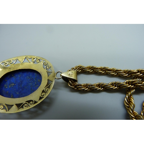 7123 - A large silver gilt lapis lazuli pendant, 16g, 6cm including bale, on a costume rope twist chain