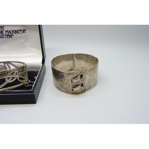 7148 - Two silver bangles, the larger buckle bangle with inscription, a/f, 73g total