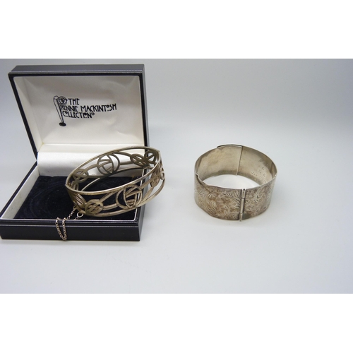 7148 - Two silver bangles, the larger buckle bangle with inscription, a/f, 73g total