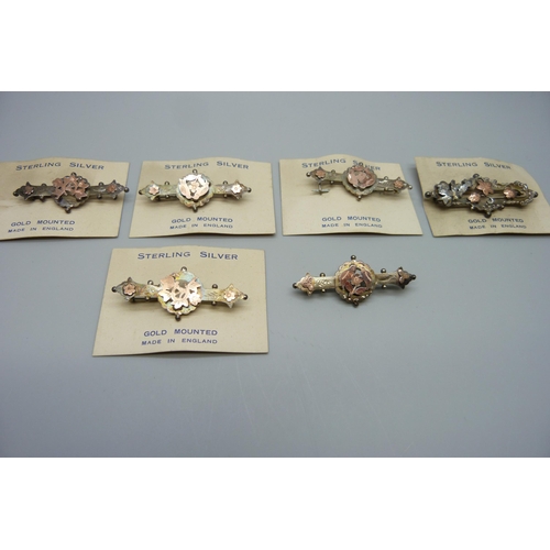 7165 - Six Victorian sterling silver and gold mounted brooches, five with original retail cards