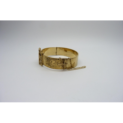 7166 - An antique gem set rolled gold bronze core buckle bangle