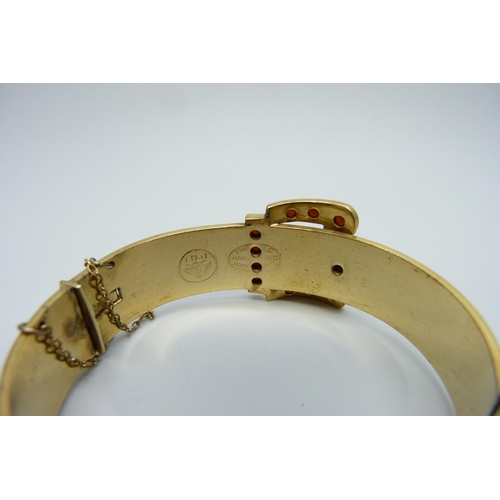 7166 - An antique gem set rolled gold bronze core buckle bangle