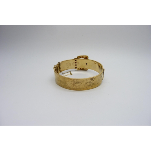 7166 - An antique gem set rolled gold bronze core buckle bangle