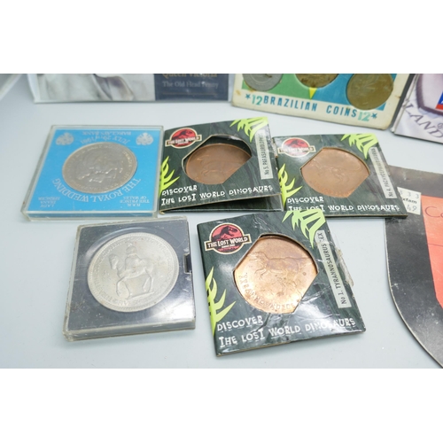 7353 - A collection of coin sets including Queen Victoria The Old Head Penny pack, three Jurassic Park meda... 