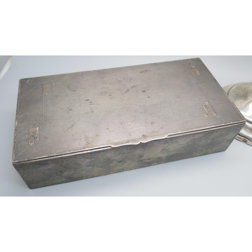 7366 - A silver cigarette box, 517g with liner, and a pair of candlesticks marked 'Sterling, Weighted & Rei... 