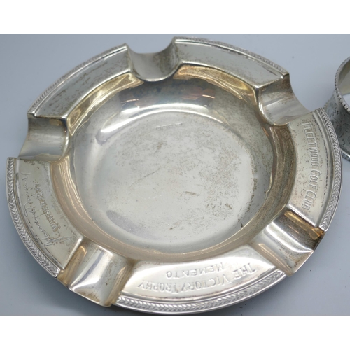 7376 - Four silver napkin rings, a silver ashtray and a silver port label, 224g