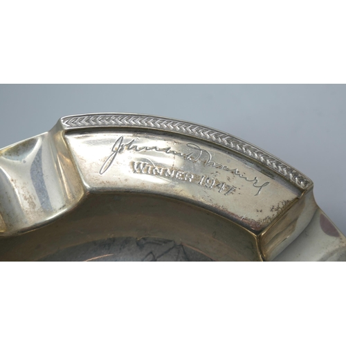 7376 - Four silver napkin rings, a silver ashtray and a silver port label, 224g