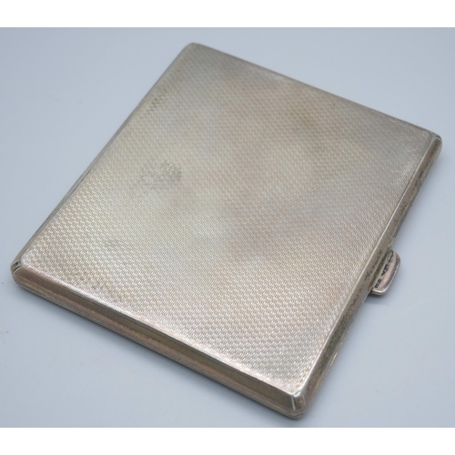 7386 - An engine turned silver cigarette case, 87g, 72mm x 81mm