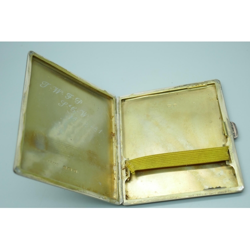 7386 - An engine turned silver cigarette case, 87g, 72mm x 81mm