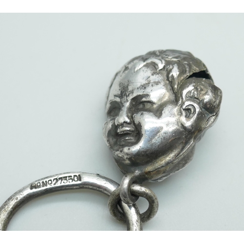 7395 - A silver rattle, Birmingham 1907, a rattle bell and a heart shaped pendant