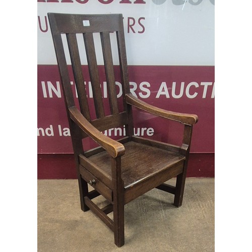 78 - An Arts and Crafts oak elbow chair, manner of Robert Lorimer