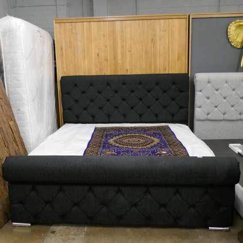 3251 - A black fabric buttoned superking size bed and mattress