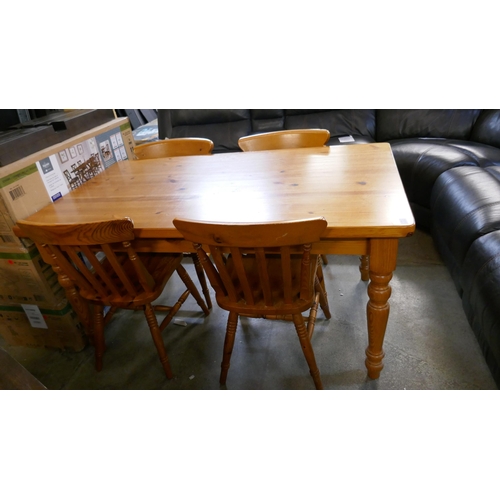 3303 - A pine dining table with four chairs