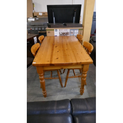 3303 - A pine dining table with four chairs