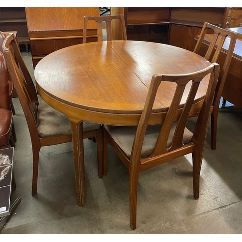 25 - A Nathan teak circular extending dining table and four chairs