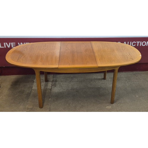 8 - A Nathan teak oval extending dining table