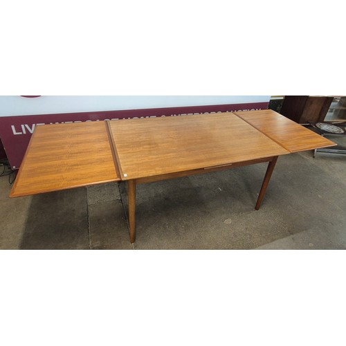 9 - A large Danish teak rectangular extending dining table