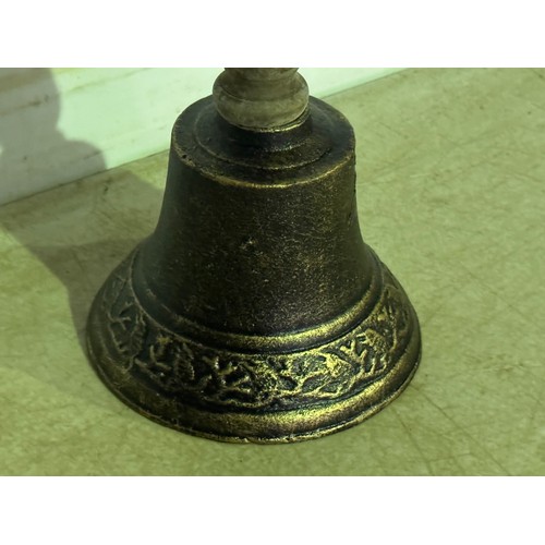 5114 - A cast metal hand bell with a wooden handle* This lot is subject to VAT