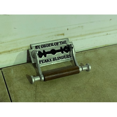 5169 - A pair of cast metal toilet roll holders - both with attached plaques including 