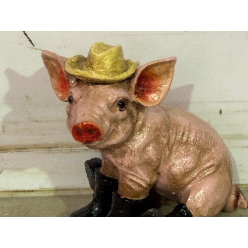 5165 - A cast metal pig ornament with boots and hat* This lot is subject to VAT