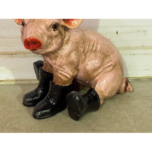 5165 - A cast metal pig ornament with boots and hat* This lot is subject to VAT