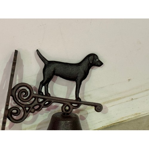 5146 - A cast metal standing dog bell with wall bracket* This lot is subject to VAT