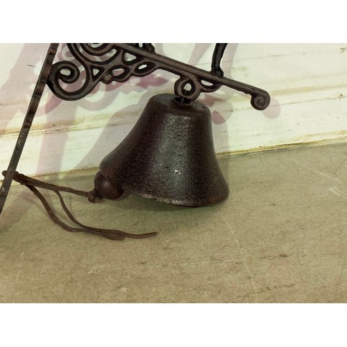 5146 - A cast metal standing dog bell with wall bracket* This lot is subject to VAT