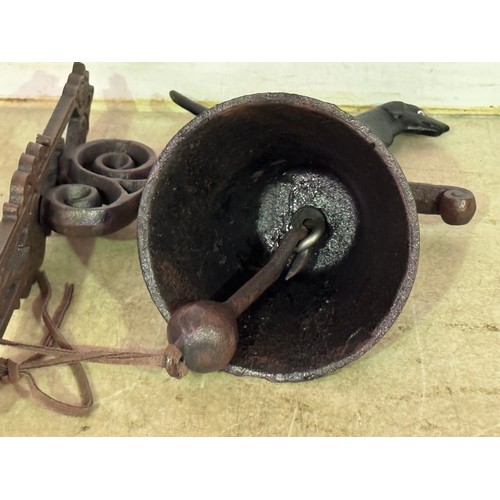 5146 - A cast metal standing dog bell with wall bracket* This lot is subject to VAT