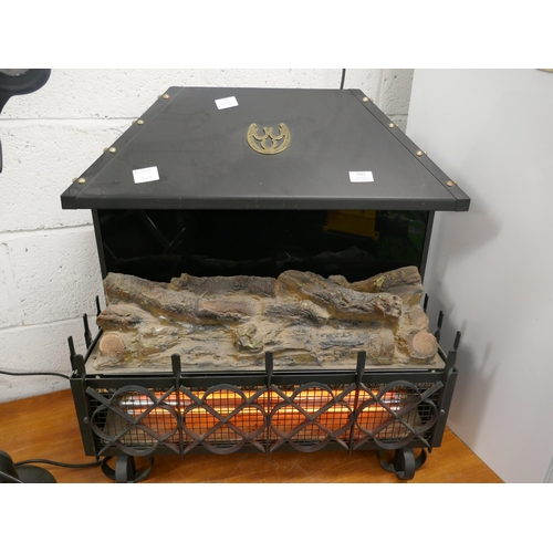 5256 - A log effect electric fire with a cast iron effect surround