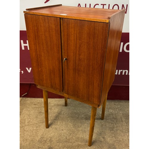 61 - A teak two door fitted record cabinet