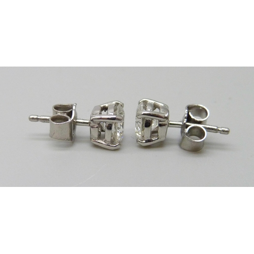 7003 - A pair of hallmarked platinum and diamond stud earrings, total diamond weight 1.40ct