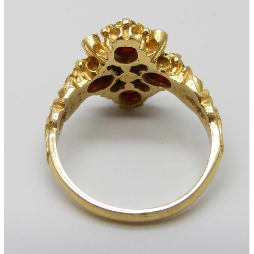 7020 - An 18ct gold antique style garnet and diamond cluster ring, 5.9g, O