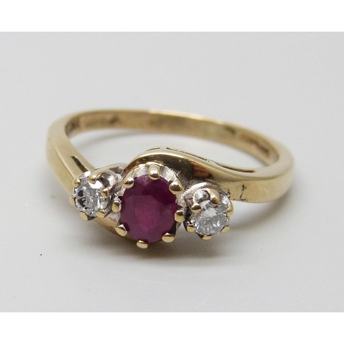 7033 - A 9ct gold, three stone ruby and diamond ring, 2.3g, M