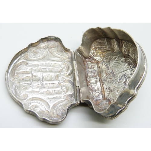 7051 - A white metal clam shell shaped box, 65mm wide