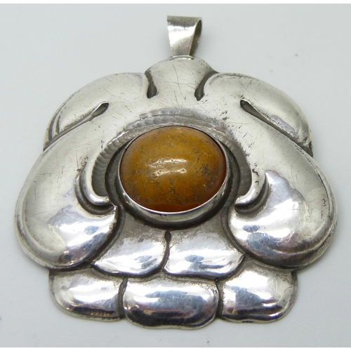 7063 - An Arts and Crafts silver pendant, M.Hammer, 5cm wide