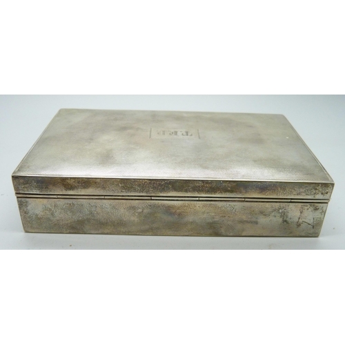 7145 - A silver cigarette box and two silver cigarette cases, (cases 174g, box 380g with liner)