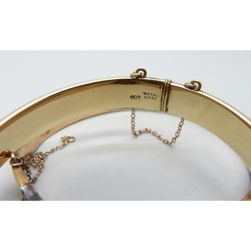 7169 - A 9ct gold bangle, 12.9g, a small silver bangle, a 9ct metal core bangle and one other