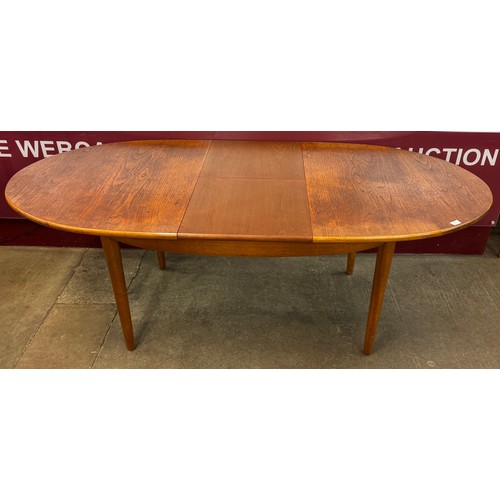 72 - A Jentique teak oval extending dining table and four teak dining chairs