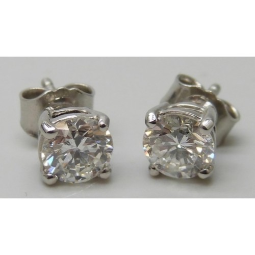 7003 - A pair of hallmarked platinum and diamond stud earrings, total diamond weight 1.40ct